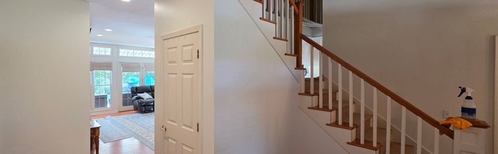 Finished foyer with fresh walls and an oak stair rail